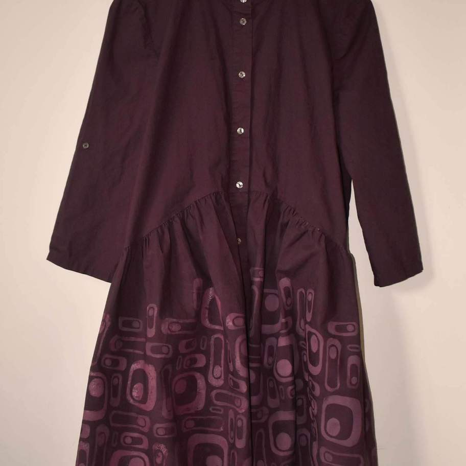 Purple button-up dress with hand-printed retrofuturist geometric patterns in pink ink cascading across the skirt.