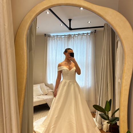 Model in pre-loved a-line wedding dress, with off the shoulder sleeves for the modern bride at The Corner Atelier, Manchester