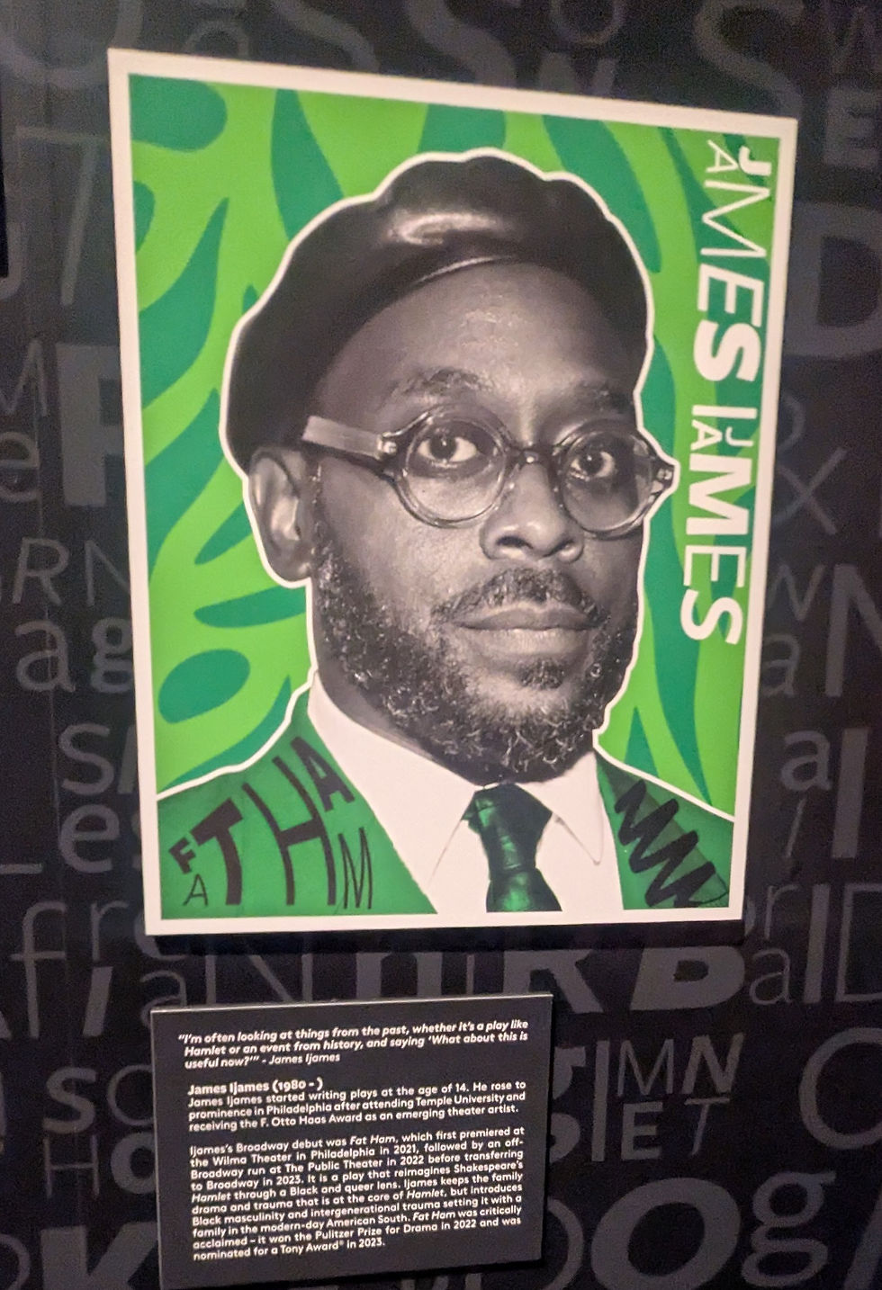 Stylized portrait of a man in a suit with glasses and a hat against a green pattern. Text includes James Ijames Background has black lettering.