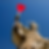 Statue of a Saint figure with a halo of stars holds a red heart-shaped lollipop against a clear blue sky. Playful and surreal mood.