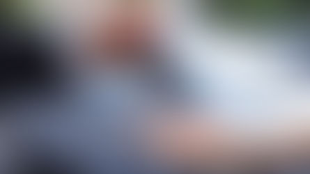 A man handing a woman the keys to a rental car.