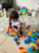 child building a tower with blocks
