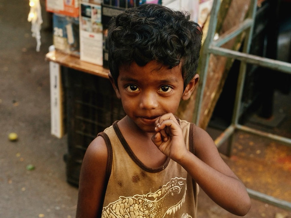 Portrait of a young boy on the streets of Jayanagar Bengaluru looking directly at the camera with curious unguarded eyes at golden hour
