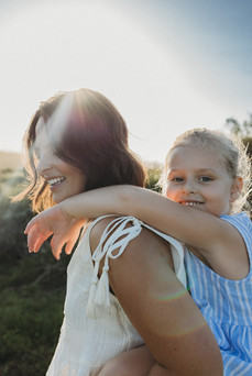 mother giving daughter a piggyback, spending quality time together