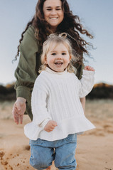 mum playing with little girl chasing 
