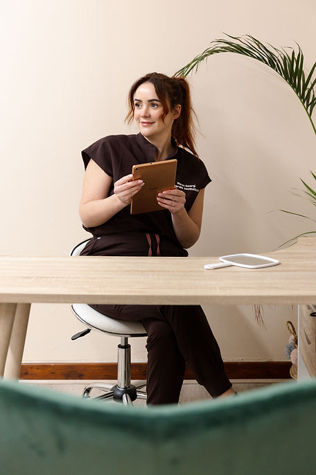nurse georgi sat at a desk with an ipad