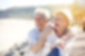 Senior couple relaxing by the sea on sunny day.jpg