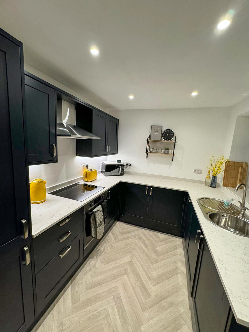 Modern dark kitchen with herringbone floor