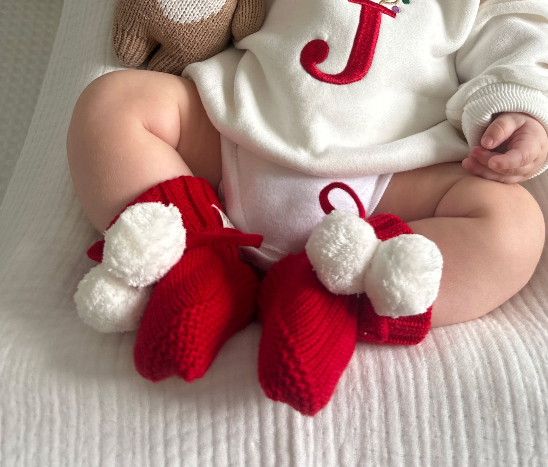 Red Knitted Booties With White Pom poms