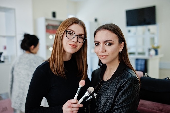 Cosmetologist applying makeup esthetician programs in orlando fl