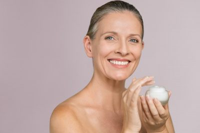 Lady with Facial Moisturizer best cosmetology schools in Orlando fl