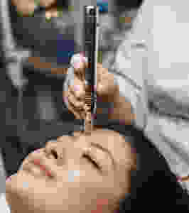 Esthetician performing facial