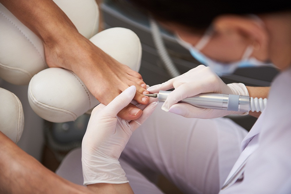 Nail tech performing pedicure