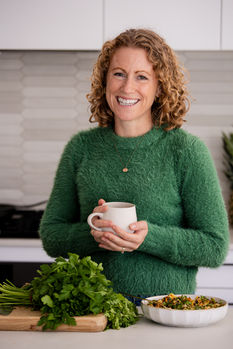 portrait of Dietitian in kitchen surround by produce