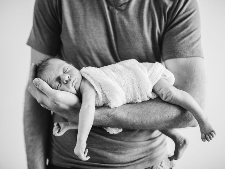 Newborn baby photography in dad arms 