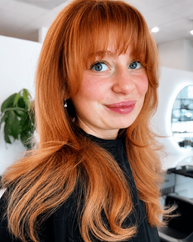 Vibrant copper hair color with curtain bangs at LUMA Salon in Charlotte NC