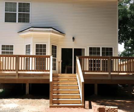 Pressure treated wood deck with centered stairs and railing
