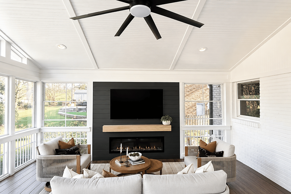 Luxury screened porch with stone fireplace and ceiling fan built by Ebony Outdoor Living in Charlotte NC
