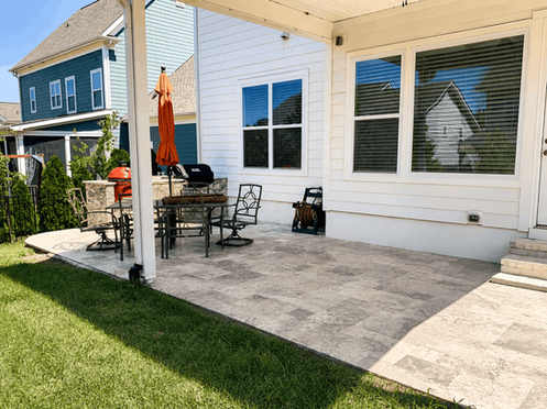 Paver patio with outdoor dining set and screened porch in Charlotte NC