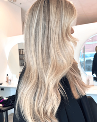 Creamy blonde balayage with soft waves at LUMA Salon in South End Charlotte