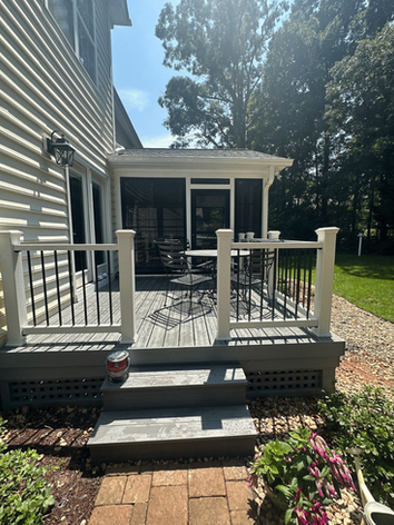 Compact deck leading into screened porch with outdoor dining space, perfect for cozy backyard gatherings in Charlotte.