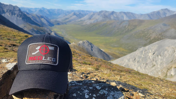 Redleg hat on top of mountain