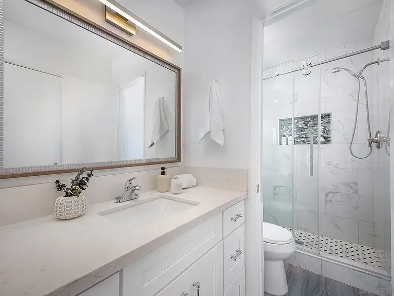 Modern bathroom staging with large mirror