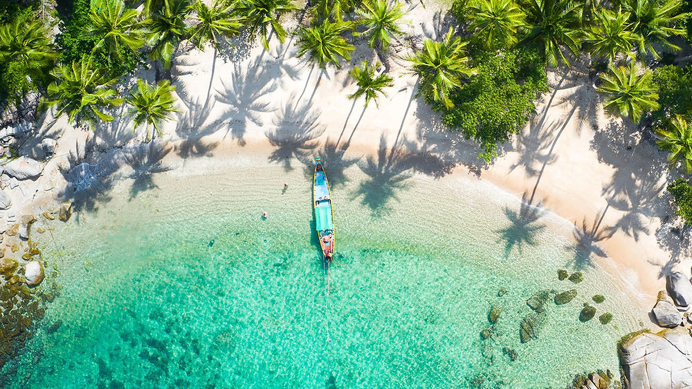 Koh Tao beach with boat in clear water