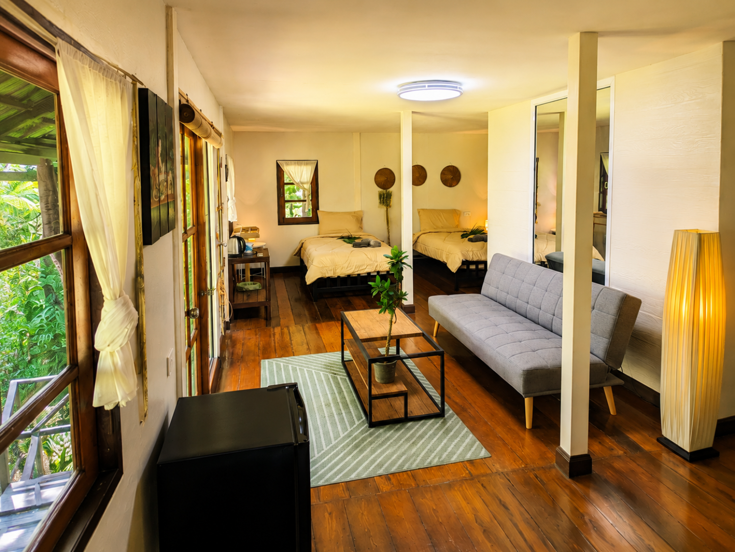 Living room of a Garden Villa with sofa and panoramic garden window