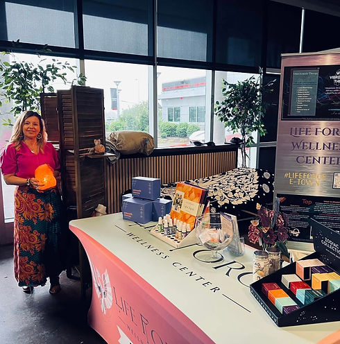 a girl standing to a essential oil stand