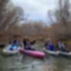 a bunch of people kayaking