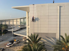 A man pressure washing at the New Orleans airport.