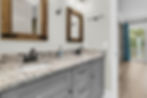 Double vanity with granite counter and rustic mirrors