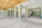 Unfinished room with concrete floor, columns, and wood ceiling