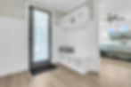 Entryway with white built-in bench and bedroom view
