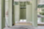 Outdoor shower stalls with light green wooden partitions