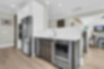 Kitchen with stainless steel appliances and beverage cooler