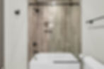Modern bathroom with tub, glass shower, black hardware