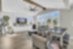 Bright living room with large windows and vaulted ceiling
