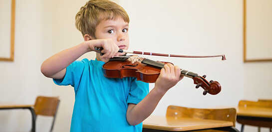 a boy playing a violin