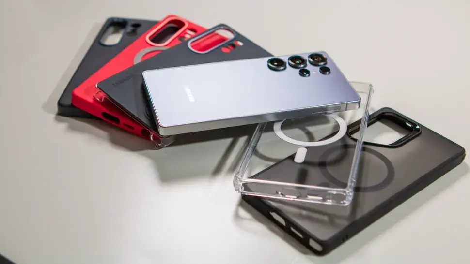 Smartphone with four colored cases, including red and clear, on a light surface. Samsung logo visible, evoking choice and protection.