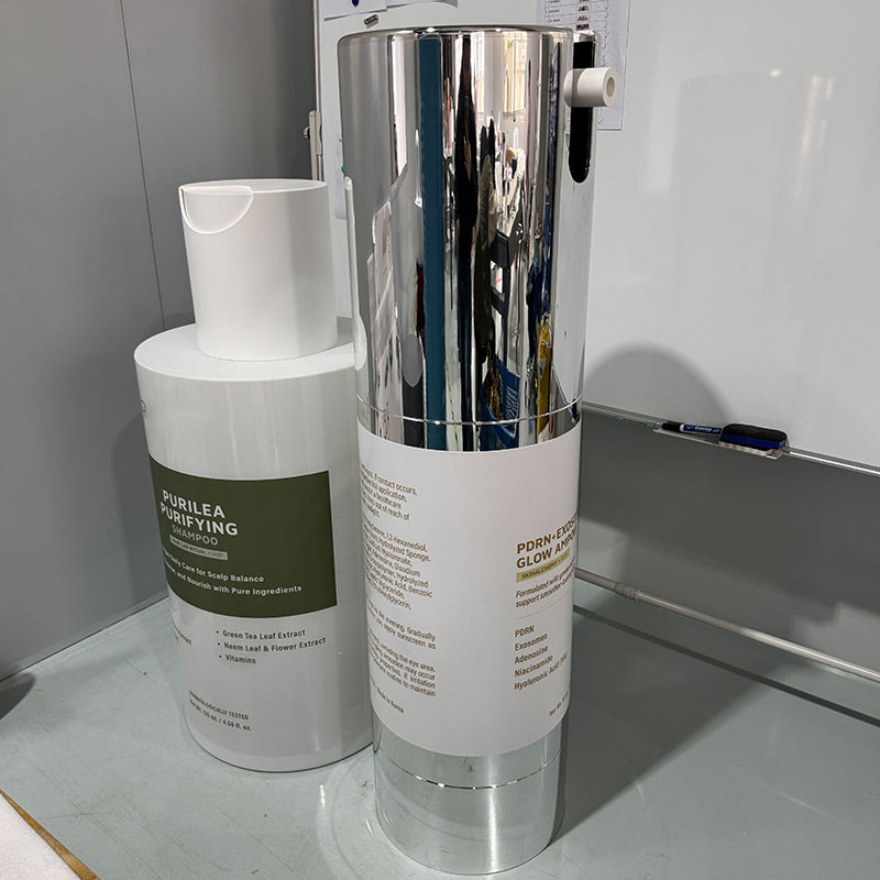 Thumbnail: Giant essence bottle display prop beside large skincare bottle prop during production