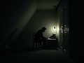 A horror writer sitting in a dark attic lit by a single lightbulb in the dead of night. .p