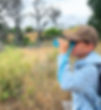 boy looking through binoculars