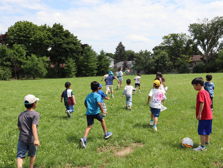 Campers playing soccer in the field