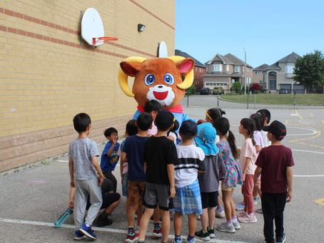 Campers gather around Nova in the schoolyard