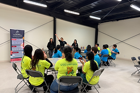 YRES staff and volunteers seated and listening to a team presentation