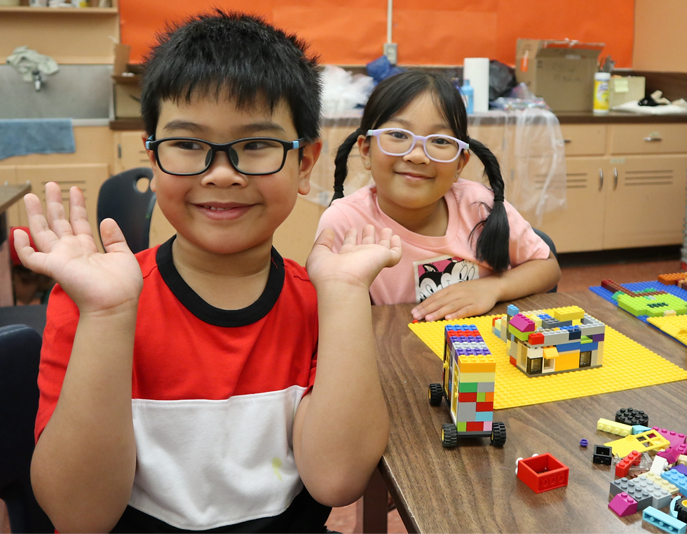 Campers proudly posing with their LEGO Arts builds.