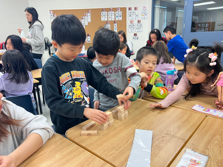 Campers playing with Jenga blocks in class
