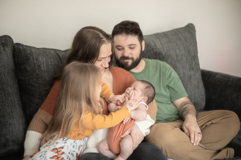 family with newborn baby at home in rochester new york